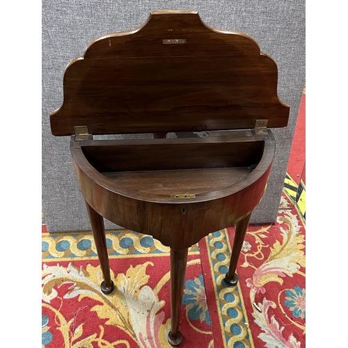 57 - Victorian flip top foot table in mahogany