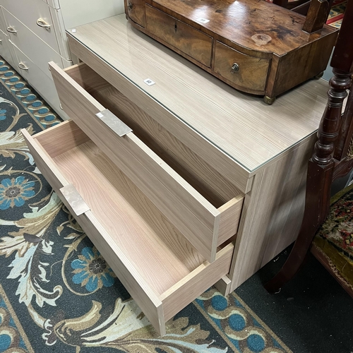 60 - Contemporary ash two drawer chest with glass top