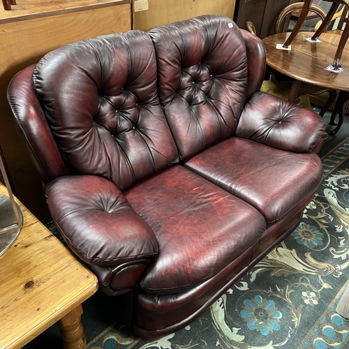 87 - Red leather two seater settee