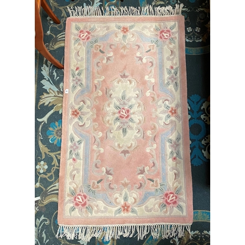 11 - Floral pattern rug with tasseled edges