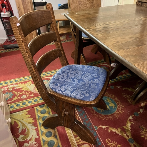 54 - Oak extending dining table with six matching chairs - complete with two extending leaves