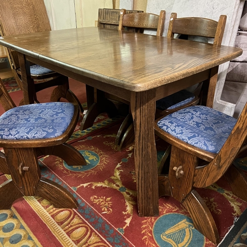 54 - Oak extending dining table with six matching chairs - complete with two extending leaves