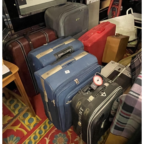 99 - Very large collection of suitcases including  travel scales