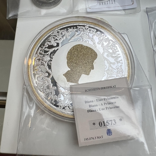 143 - Two Princess Diana memorial coins with authenticity certificate