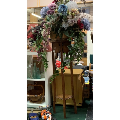 382 - Edwardian oak plant stand with large Bouquet of faux flowers