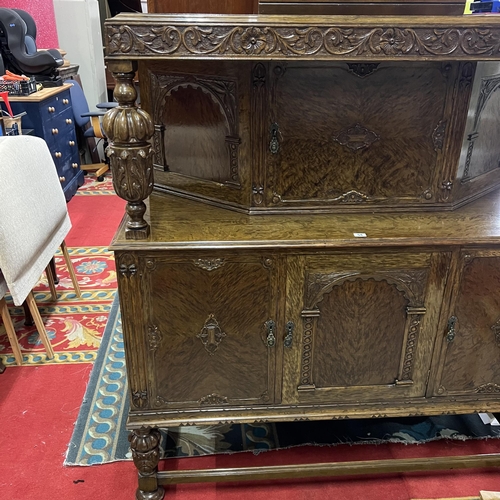 54 - BURR WALNUT HEAVILY CARVED BUFFET SIDEBOARD WITH TUDOR STYLE CARVED COLUMNS AND LEGS