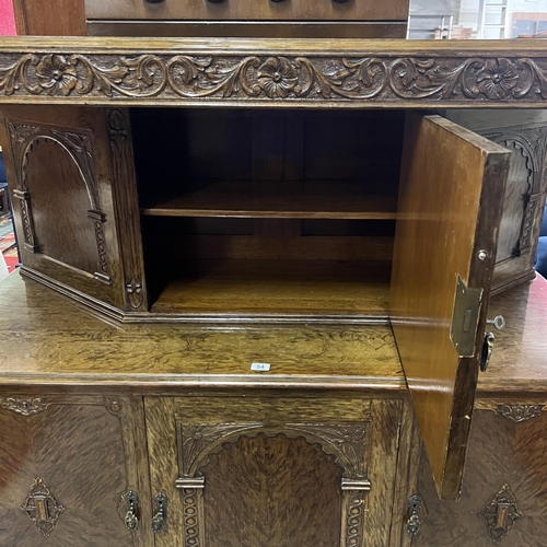 54 - BURR WALNUT HEAVILY CARVED BUFFET SIDEBOARD WITH TUDOR STYLE CARVED COLUMNS AND LEGS