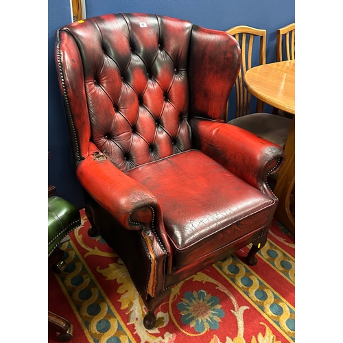 61 - OXBLOOD LEATHER WINGED ARMCHAIR ON QUEEN ANNE LEGS, BUTTON BACKED.