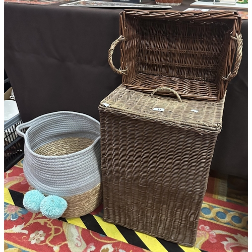 11 - THREE WICKER STYLE BASKETS, INCLUDING A LAUNDRY BASKET.