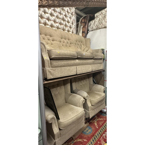 67 - THREE SEATER WING BACK SETTEE AND TWO WING BACK ARM CHAIRS WITH BUTTON BACK.