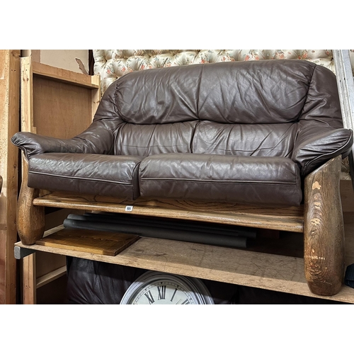 105 - BROWN LEATHER TWO SEATER SETTEE ON OAK FRAME