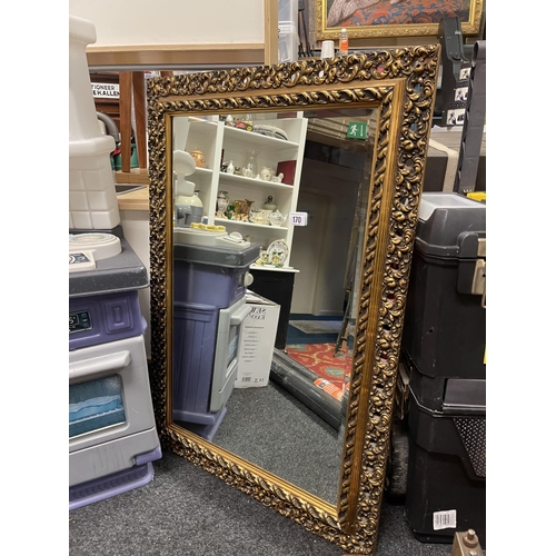 170 - LARGE BEVELLED GLASS MIRROR IN ORNATE GOLD DECORATIVE FRAME