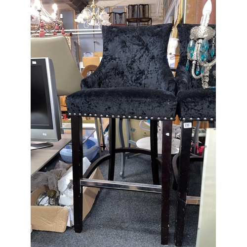 234 - BLACK VELVET HIGH BAR STOOL WITH STUDS PUNCTUATING THE FRONT AND SIDE RAILS WITH DECORATIVE METAL BU... 