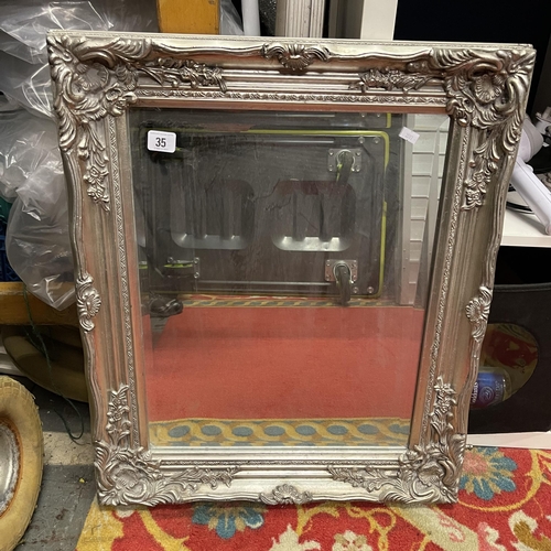 35 - ORNATELY FRAMED BEVELLED GLASS MIRROR