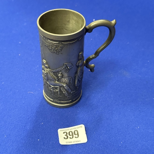 399 - A TRIELING SMALL EMBOSSED PEWTER TANKARD