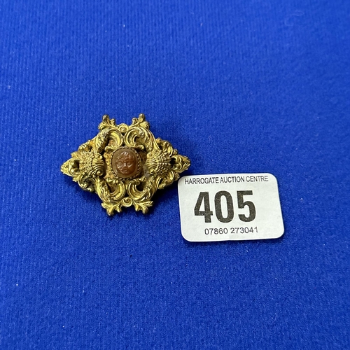 405 - GOLD PLATED ORNATE BROOCH WITH CARVED CENTRE STONE