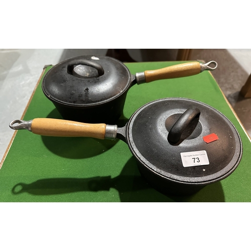 73 - TWO CAST IRON PANS WITH LIDS