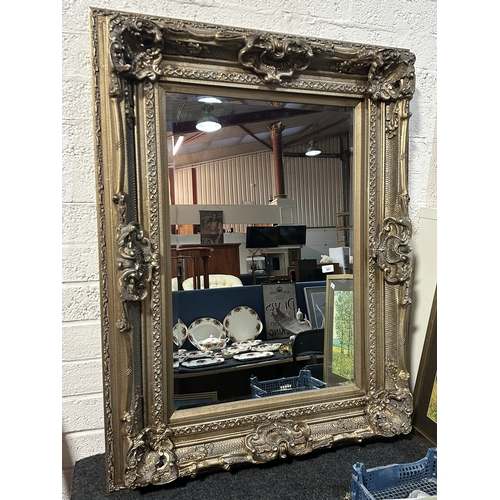 307 - VICTORIAN HEAVILY CARVED GILT FRAMED BEVELLED GLASS MIRROR