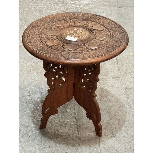 74 - CARVED INDIAN HARDWOOD TABLE WITH INLAID CENTRE DESIGN