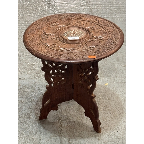 75 - CARVED INDIAN HARDWOOD TABLE WITH INLAID CENTRE DESIGN