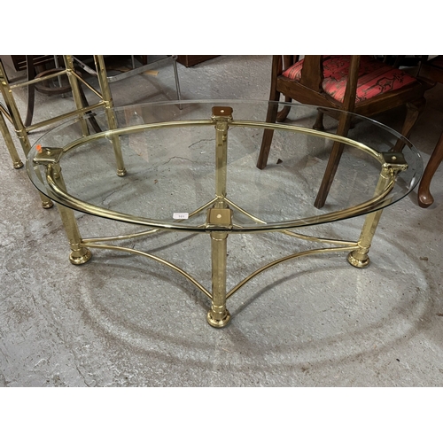 39 - 24 CT GOLD PLATED COFFEE TABLE ON COLUMN SUPPORTS WITH BEVELLED EDGE TOUGHENED GLASS OVAL TOP PURCHA... 