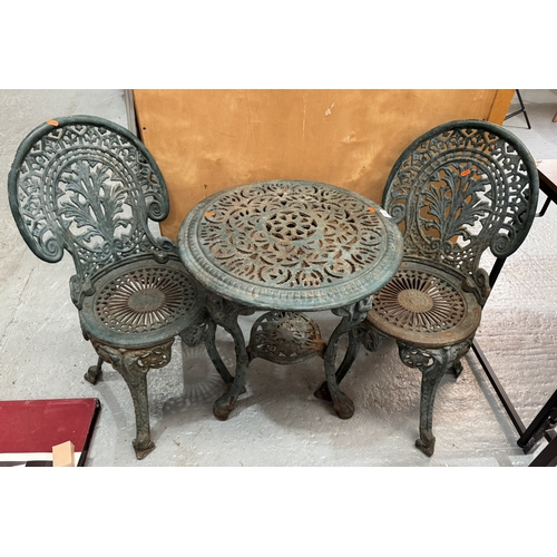 125 - CAST IRON GARDEN TABLE AND TWO CHAIRS