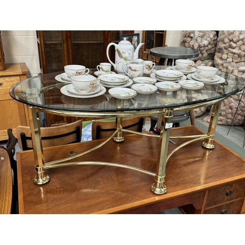 39 - 24 CT GOLD PLATED COFFEE TABLE ON COLUMN SUPPORTS WITH BEVELLED EDGE TOUGHENED GLASS OVAL TOP PURCHA... 