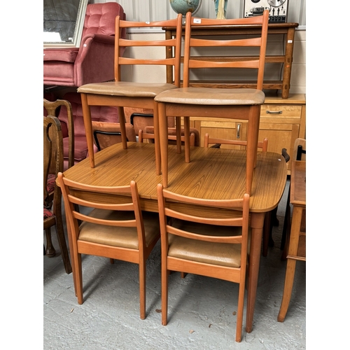 41 - 1970S TEAK EXTENDING DINING TABLE AND SIX LADDER BACK CHAIRS