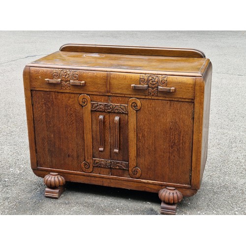41 - ART DECO OAK SIDEBOARD WITH CARVED FLORAL MOTIFS AND HANDLES