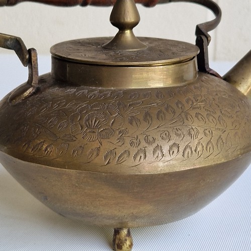 64 - ASIAN BRASS TEAPOT WITH WOODEN HANDLE AND DECORATIVE ENGRAVINGS