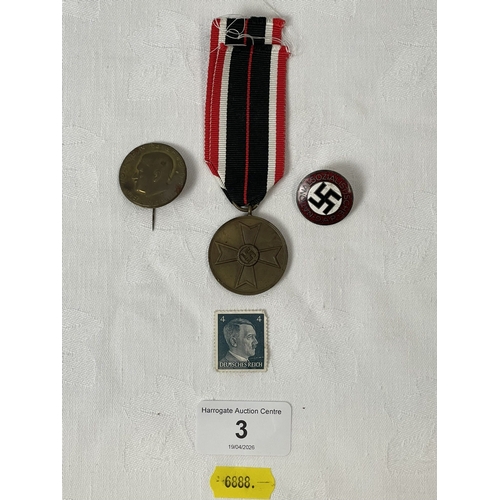 3 - GERMAN WW2 MERIT MEDAL AND TWO PIN BADGES AND A HITLER STAMP