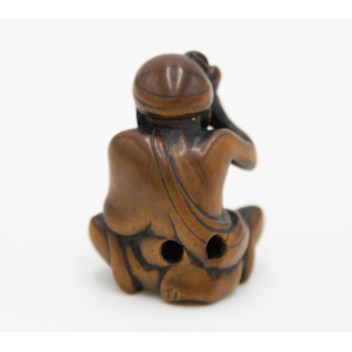 177 - Title: Wood netsuke of a seated man pounding mochi
Date: 19th century
Size: approx. (H) 3.7 x (W) 3.... 