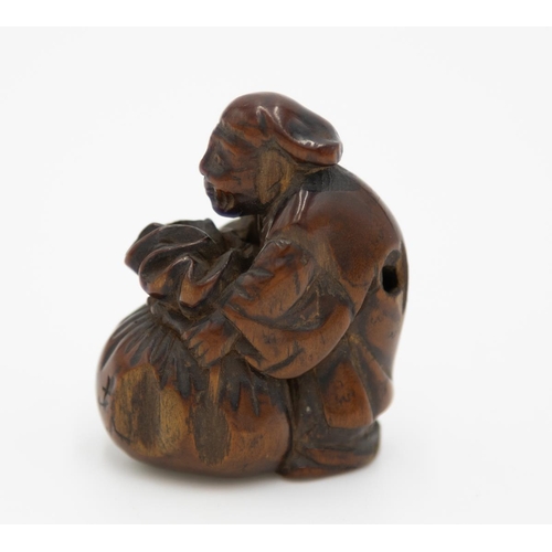 178 - Title: Wood netsuke of a merchant with a sack
Date: 19th century
Size: approx. (H) 4.3 x (W) 2.5 x (... 