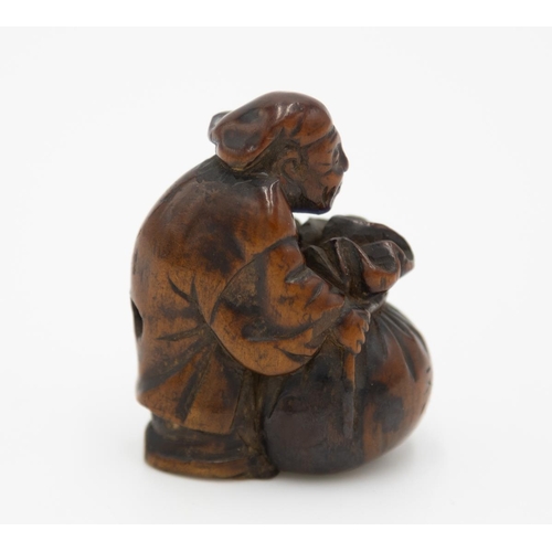 178 - Title: Wood netsuke of a merchant with a sack
Date: 19th century
Size: approx. (H) 4.3 x (W) 2.5 x (... 