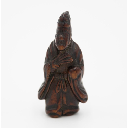 179 - Title: Wood netsuke of a standing courtier holding a fan
Date: 19th century
Size: approx. (H) 5.7 x ... 