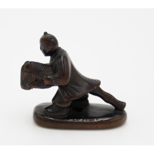 181 - Title: Wood netsuke of a karako (Chinese boy) playing with a harukoma (hobby horse)
Date: 19th centu... 