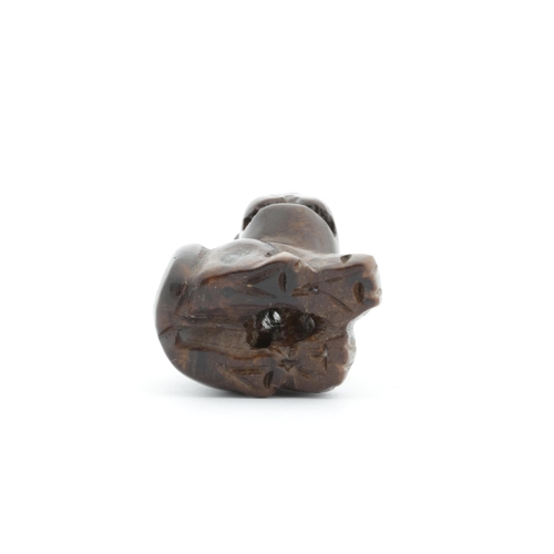 20 - Title: A wooden netsuke of a dog
Date: 19th century
Size: (H) 3.2 x (W) 2.8 x (D) 2.0 cm
Condition: ... 