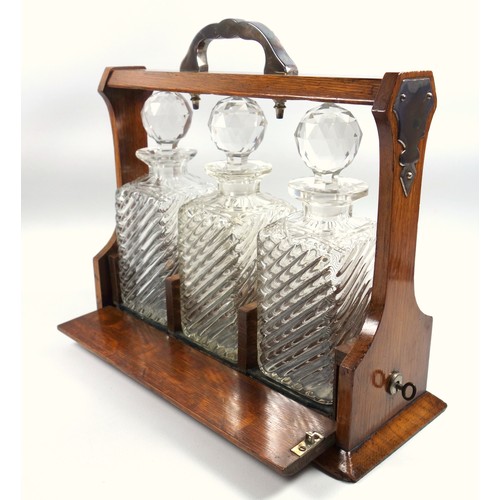 479 - Late Victorian oak tantalus with silver plated mounts and three wrythen and cut glass decanters, (wi... 