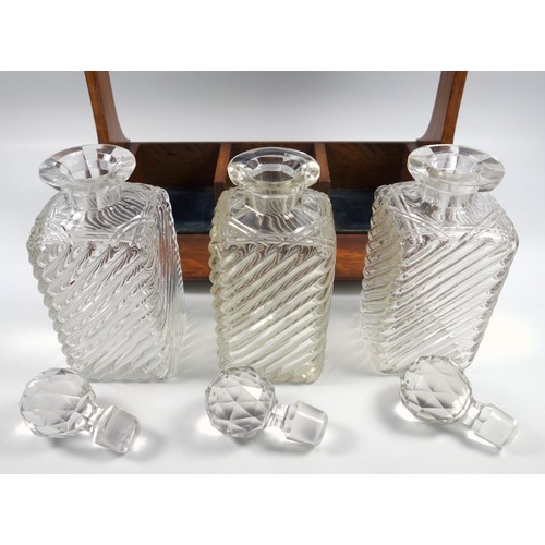 479 - Late Victorian oak tantalus with silver plated mounts and three wrythen and cut glass decanters, (wi... 