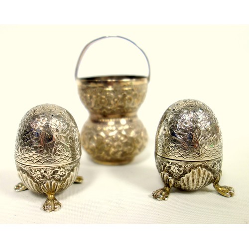 438 - Two Indian silver egg form salts, finely engraved with hunting scene, on claw feet and a small waist... 