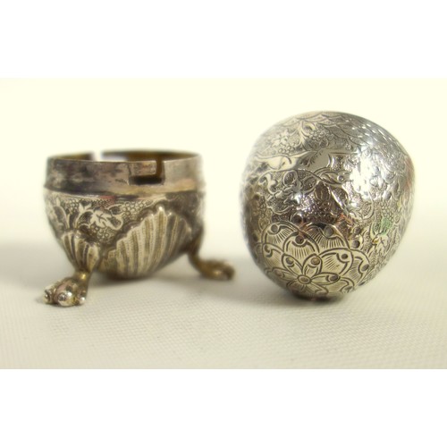 438 - Two Indian silver egg form salts, finely engraved with hunting scene, on claw feet and a small waist... 