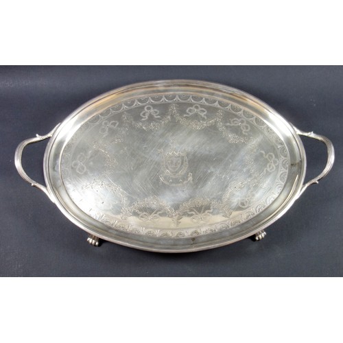 407 - George III Irish silver oval tray with reeded rim and loop handles, chased with a floral border, swa... 