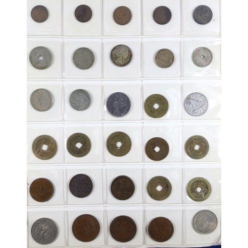 70 - Album containing 14 sheets of coins, British, Colonial and other silver and copper coins of the worl... 