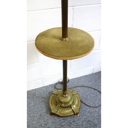 140 - Brass standard lamp with reeded column, and velour tier, on a fluted circular base, four feet, H.122... 