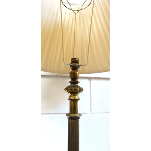 140 - Brass standard lamp with reeded column, and velour tier, on a fluted circular base, four feet, H.122... 