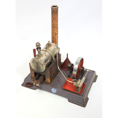 182 - German Wilesco tinplate stationary live steam engine with fire box, chimney and funnel, on a plinth ... 