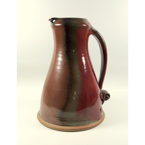 190 - Mike Braisher large stoneware jug with red and brown glaze and scroll handle, impressed mark, 35 cm