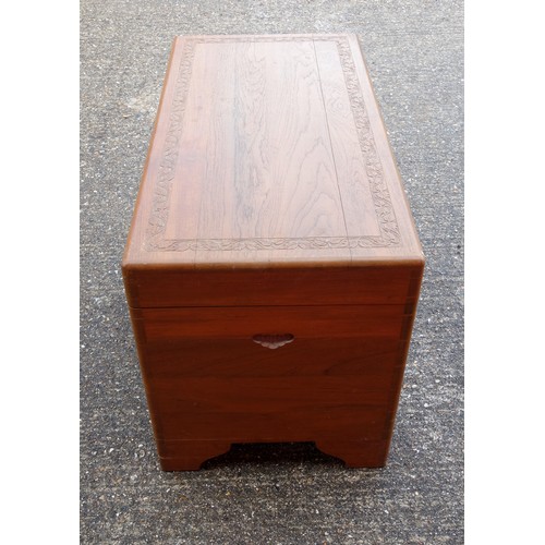 327 - Oriental teak chest with carved bands, hinged top and camphorwood lined interior with sliding tray, ... 