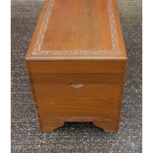 327 - Oriental teak chest with carved bands, hinged top and camphorwood lined interior with sliding tray, ... 