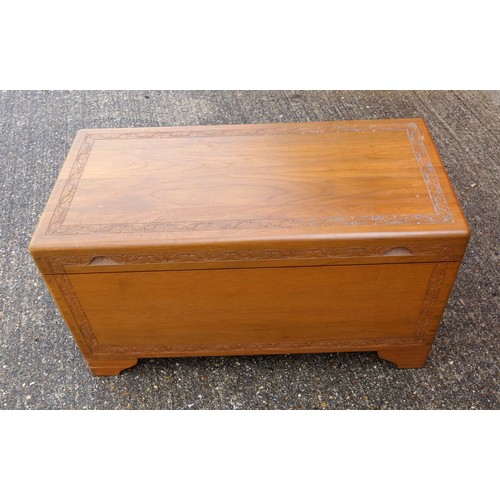 328 - Oriental teak chest with carved bands, hinged top and camphorwood lined interior with sliding tray, ... 